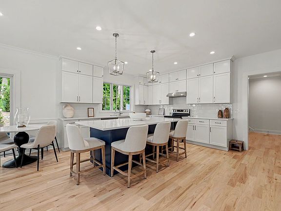 Featuring custom cabinetry, expansive quartz countertops, and professional-grade appliances.