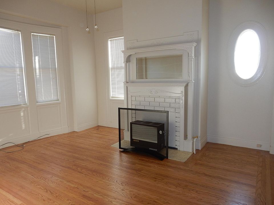 Living room with original hardwood floors and detailing