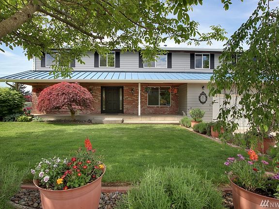 Beautiful landscaping & inviting covered porch.