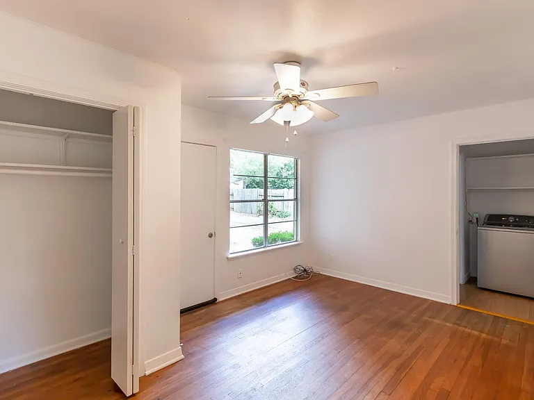 Primary bedroom with half bath and washer.