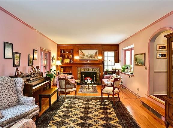 View from the dining room into the living room.  French doors at far left lead to three season sunroom.  Note graceful archways.