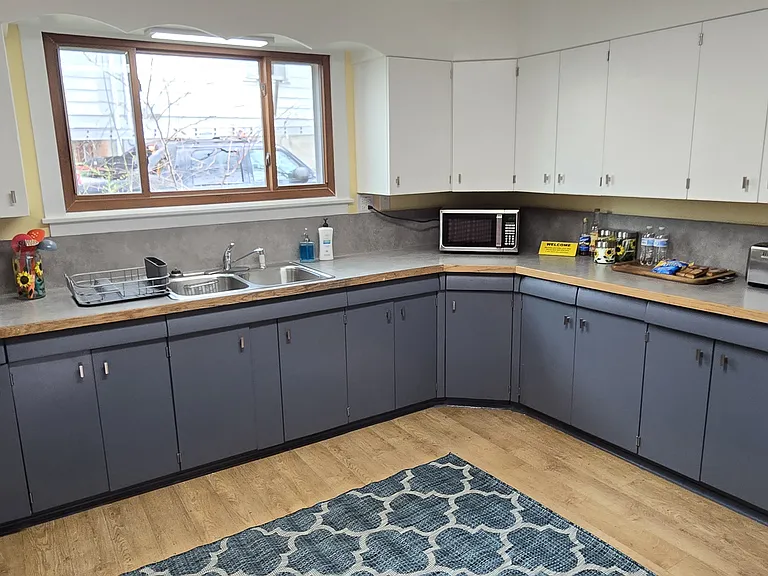Kitchen with gas range/oven, refrigerator, washer, dryer.