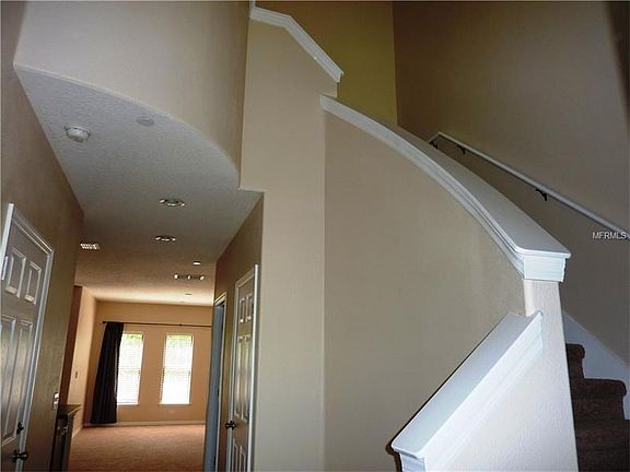 Dramatic entryway with railed stairway. Freshly painted and all new carpet.