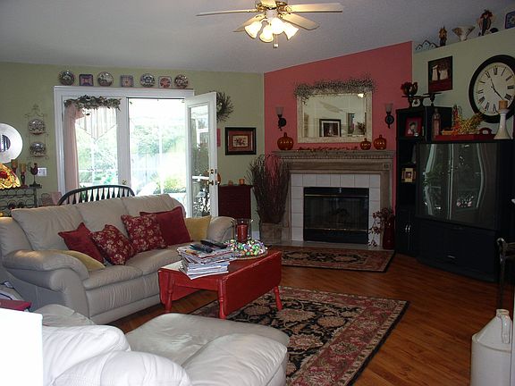 Family room with gas log fireplace... opens to pool area
