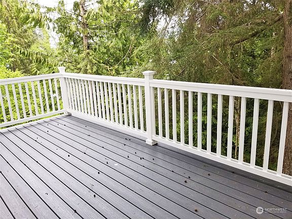 Spacious main level deck off of the greatroom.   >
