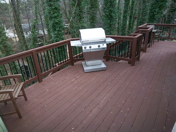 Large deck overlooking wooded backyard
