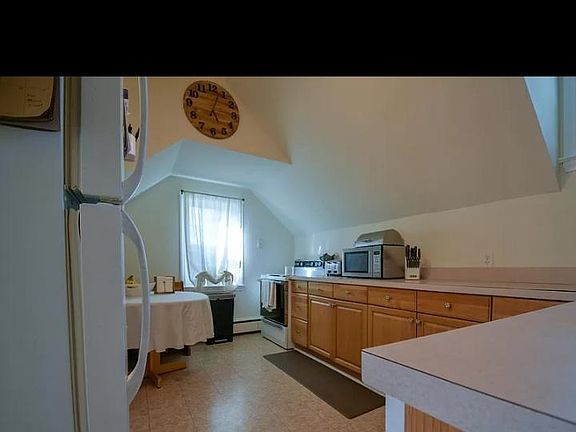 Kitchen with ample counterpart, dishwasher, an eat in space and 2 windows