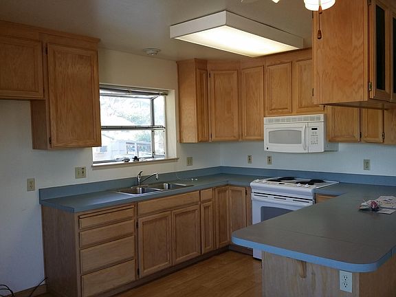 Kitchen area with electric range and oven. Microwave over range
