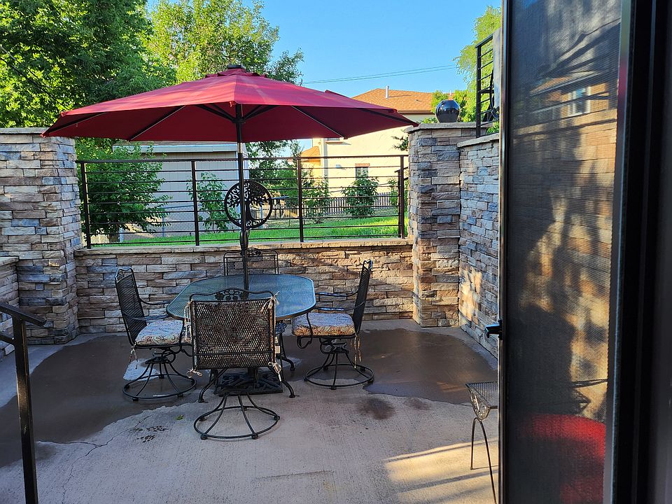 Private Courtyard with Wrought Iron Table, 4 Swivel Rocker Chairs, Umbrella. Glider with 2 Side Tables to the side