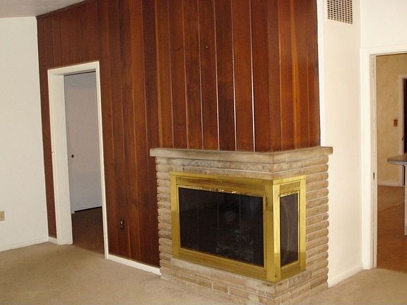 Cozy family room right off the kitchen with corner stone fireplace 