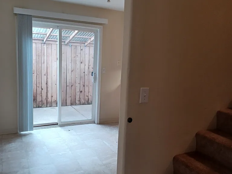 Dining area with sliding door to the covered fenced patio