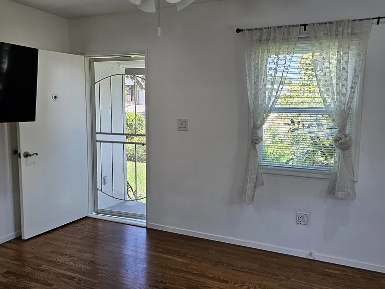 Front room, showing front door and window.