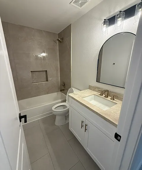 Hall bath with new tile, new plumbing, and brand new cabinets
