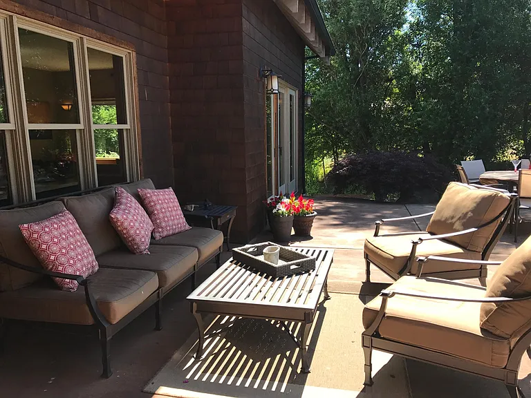 outdoor living overlooking the gardens and creek