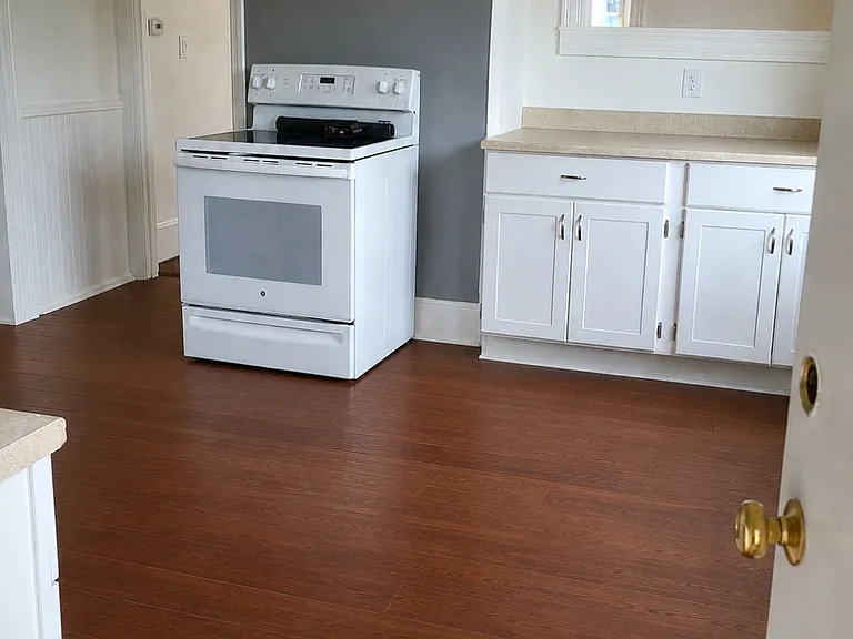 kitchen (includes fridge, stove). sink opposing side). new floors, paint and ceiling fan. Partially rendered photo as flooring is going in week of August 3rd.