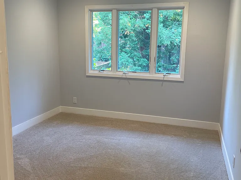 Bedroom with views of the rear yard