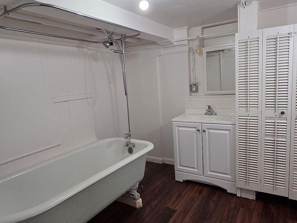 Extra large bathroom with clawfoot tub and vanity.