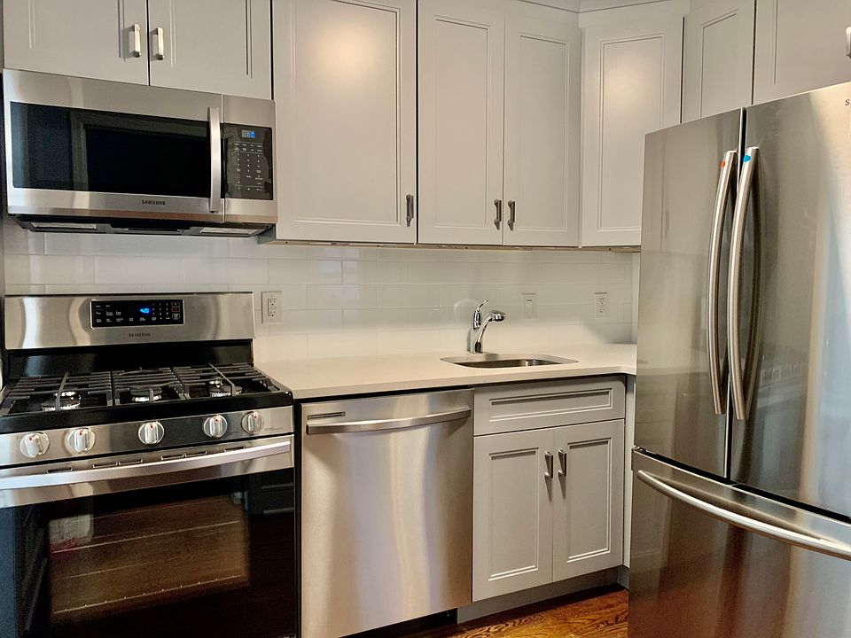 Beautiful, new kitchen with stainless steel appliances and quartz countertops.