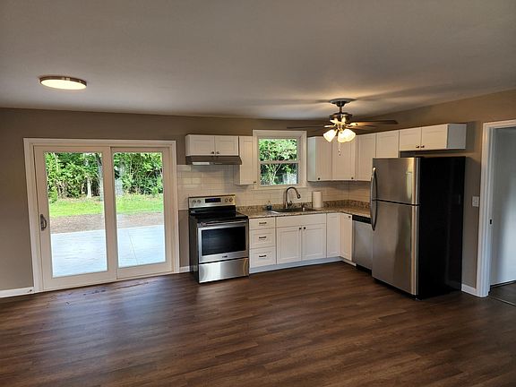New open kitchen leading to new concrete patio