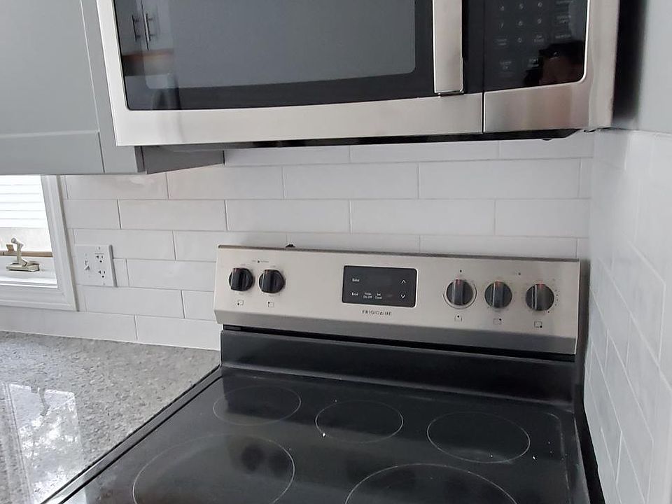 New stainless steel stove/microwave combo with internal fan.