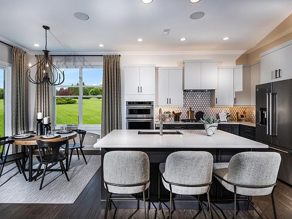 Well-appointed kitchen overlooks casual dining area