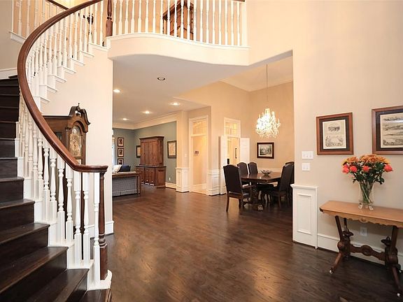 Beautiful entry with second staircase off of kitchen.
