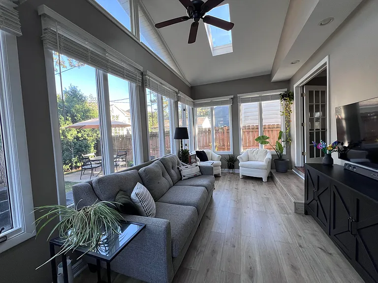 Sunroom off the kitchen. Great second living space or room for a large dining table.