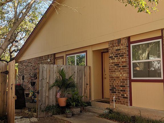 View of front door and gate to fenced in backyard