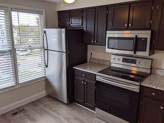 Kitchen with new vinyl plank floor, granite countertops and stainless appliances!