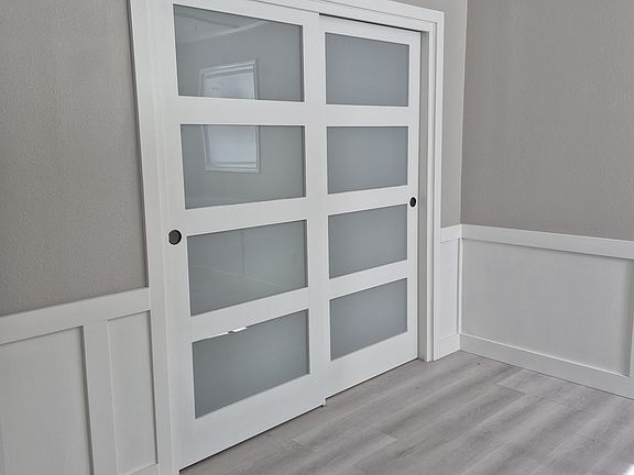 Second bedroom with 2 windows and loads of architectural details.