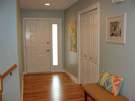 The elegant entry way has all new hardwood floors that glow. You have views of the extra wide trim,living room and the beautiful built-in cabinet that stays