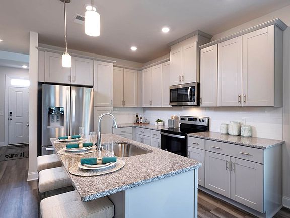 A large kitchen island and plenty of cabinet space makes the at-home-chef feel right at home.