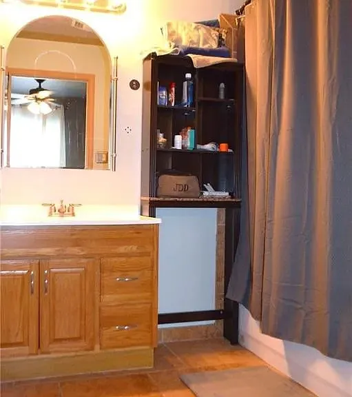 The actual furnishings are different than this photo but this is the vanity sink and the bathtub shower area in the shared full size bathroom