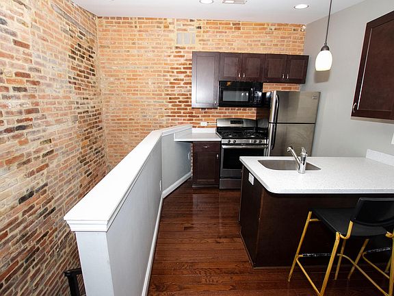 Kitchen with stainless appliances, dishwasher & granite countertops & island