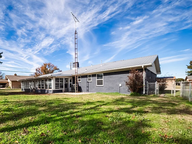 Side exterior view showcasing the home's ranch-style layout and large lot