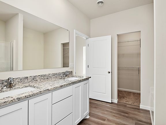 The master bathroom has a dual sink vanity.