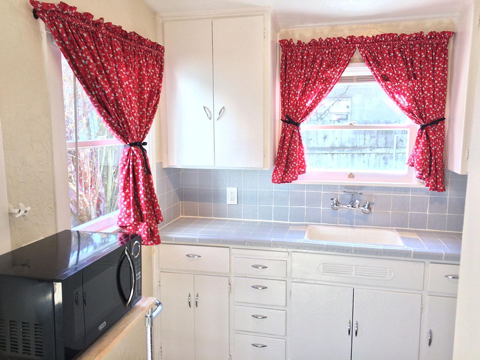 A darling sun-drenched kitchen with windows that look out onto your own private gated backyard.