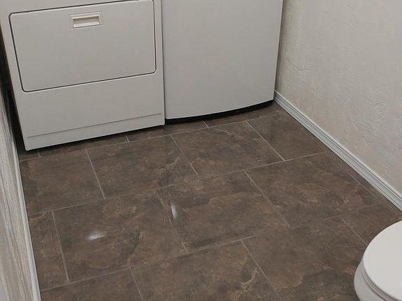 Laundry room with washer and dryer and half bath