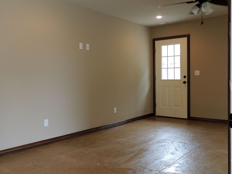 living room. has stamped concrete flooring