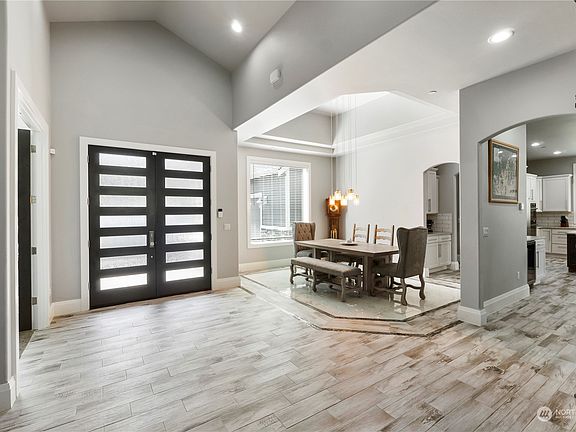 Inset marble tile floors define the formal dining space and mimic the coffered ceiling.>