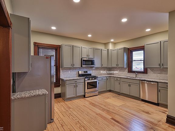 The kitchen has all new appliances, lighting, cabinets, and refinished floors.
