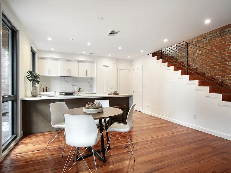The dining area and kitchen are equipped with high-end, built-in Bosch appliances.