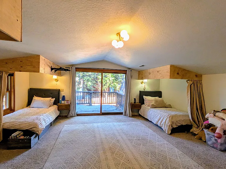 Second large upstairs suite includes full bath and private deck overlooking the backyard