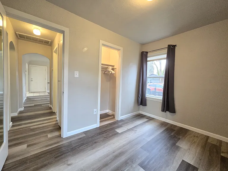 Bedroom 2 with closet, looking into hallway to living room.