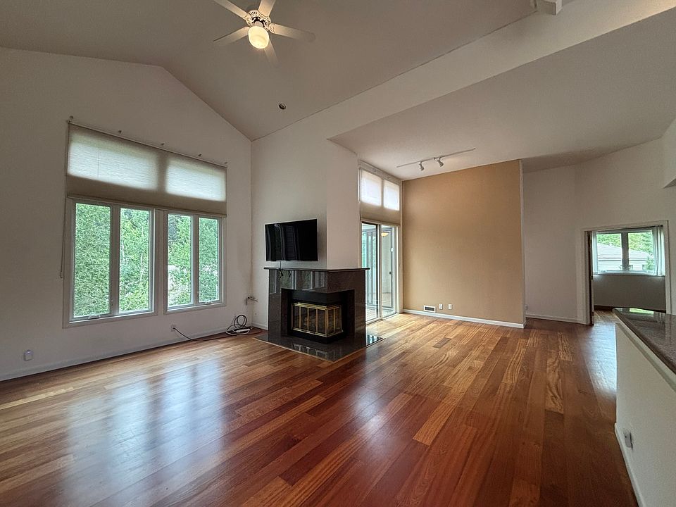 Living room with dining area and wet bar. High Ceilings with ceiling fan.