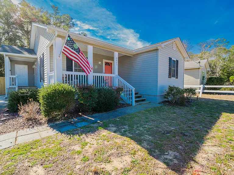 House has front entrance and side entrance. As well as enclosed outdoor shower off side entrance.