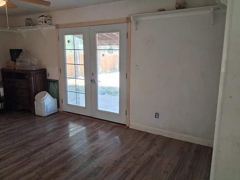 Family room door leads to acre fence back yard