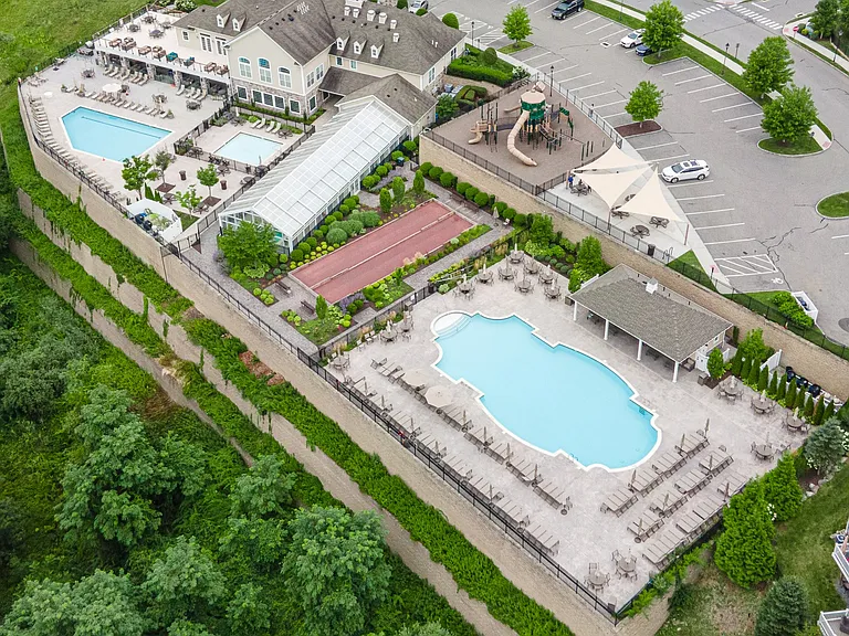 Resort-style living awaits at the Rivington clubhouse! Outdoor amenities include two swimming pools, tennis, pickleball, basketball, bocce, a playground, and expansive outdoor patios with lounge and grill areas.