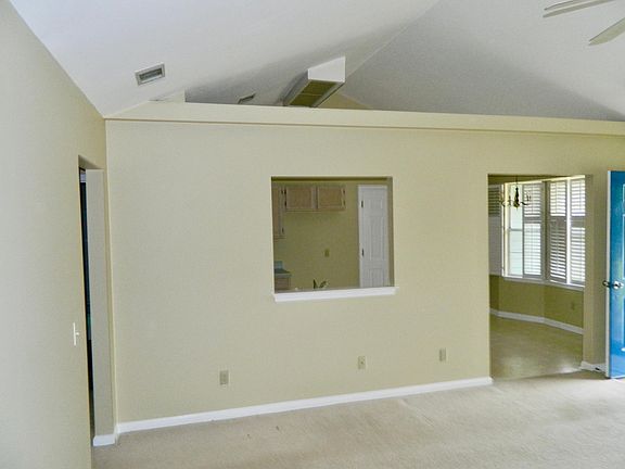 Vaulted ceiling and view into kitchen