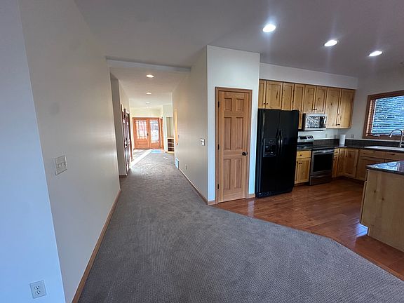 Main hallway and entryway door toward the front of the home.